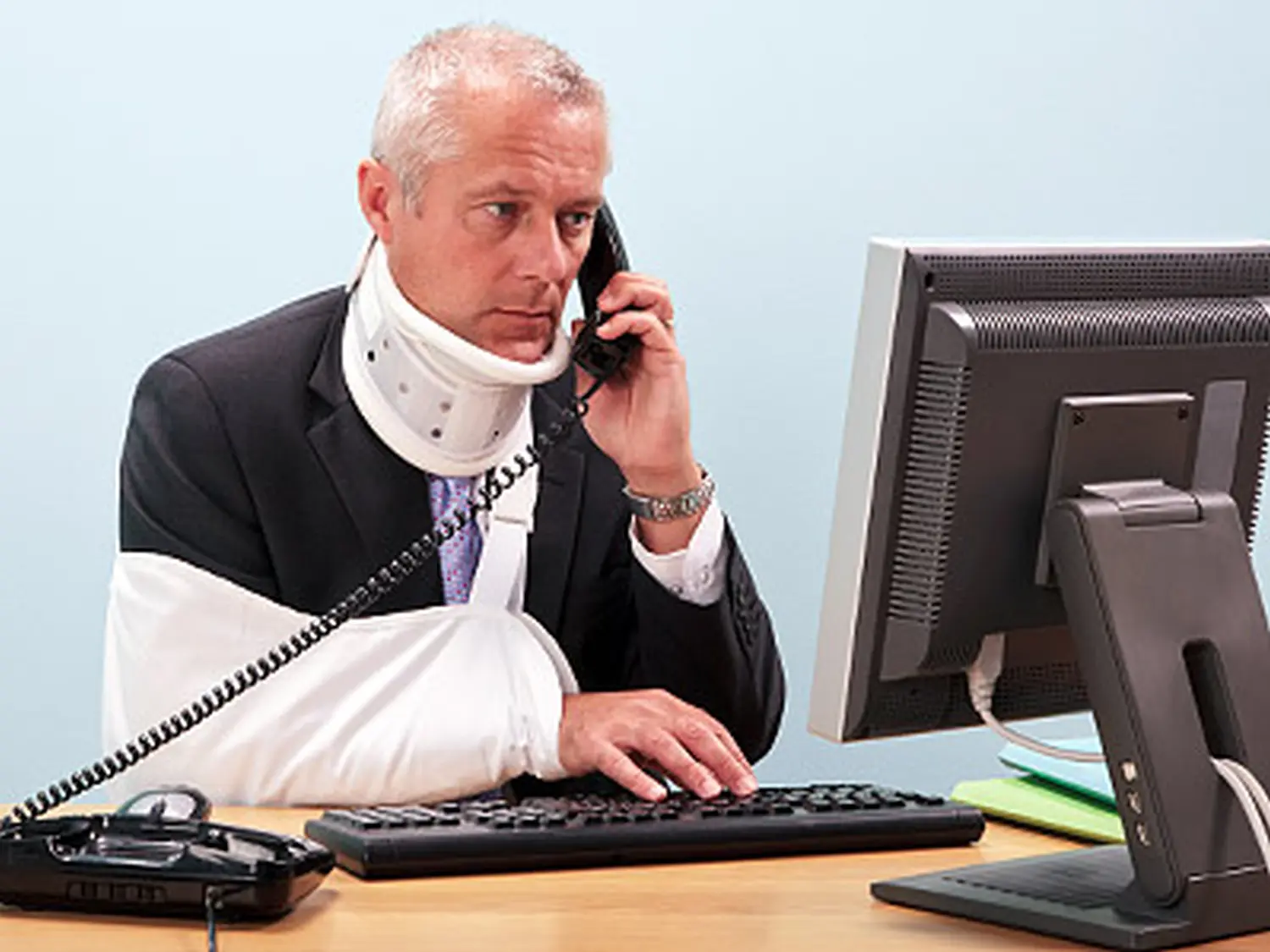 Ein Patient in der Praxis nimmt sein Telefongespräch entgegen von Bauer GmbH